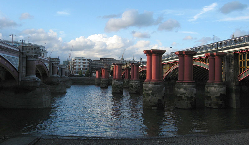 View from South Bank between Blackfriars and Blackfriars Railway bridges, showing train. Photo by Alethe, Creative Commons
